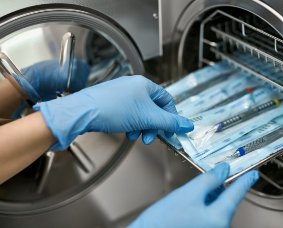 Dental team member selecting sterilized dentistry tools