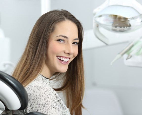 Woman smiling during dental treatment