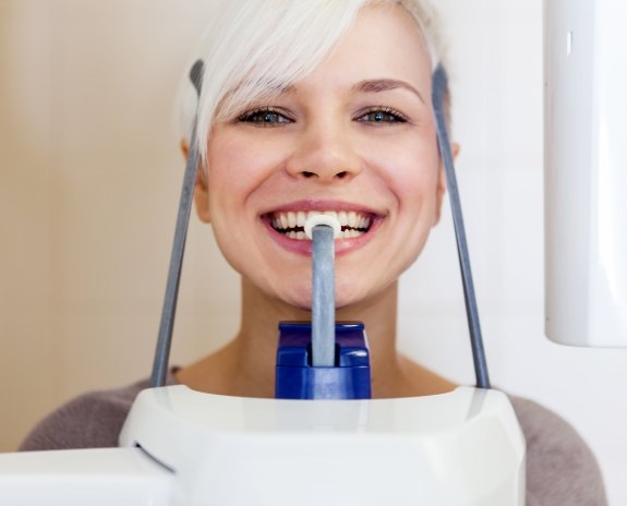 Woman receiving 3 D C T cone beam digital x-ray scans