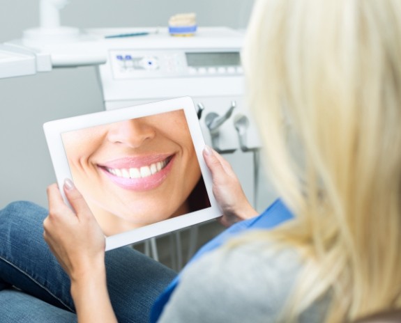 Woman looking at interactive mouth tours on tablet computer