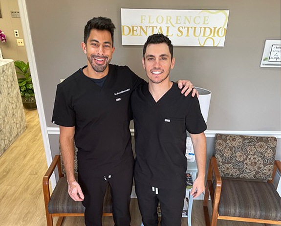 Two smiling dentists in dental office