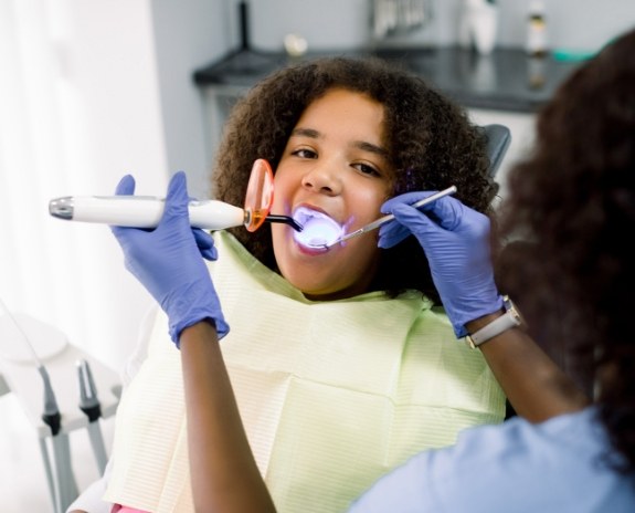 Young patient receiving dental sealants