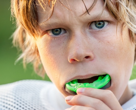 Teen placing an athletic mouthguard