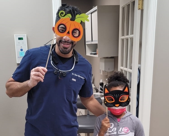 Doctor Nikoonezhad and young patient wearing costume masks