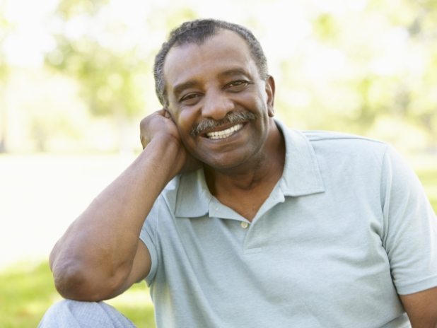 Man smiling after replacing missing teeth