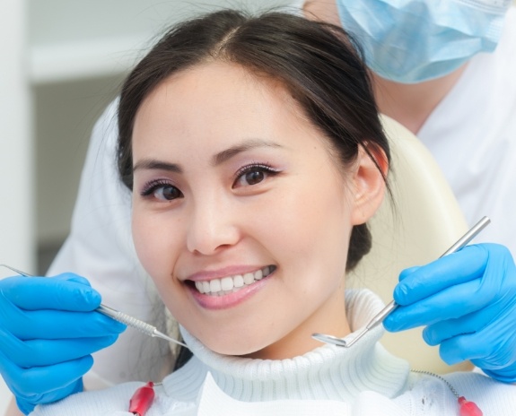 Woman receiving dental checkup and teeth cleaning