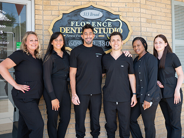 The Florence Dental Studio dentists and team smiling after providing dental services