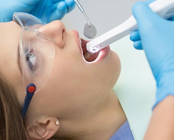 Dentist using intraoral camera to capture smile images