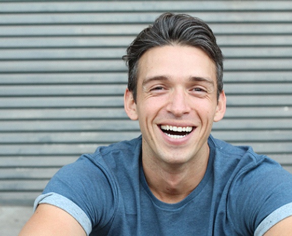 man smiling after getting veneers in Florence